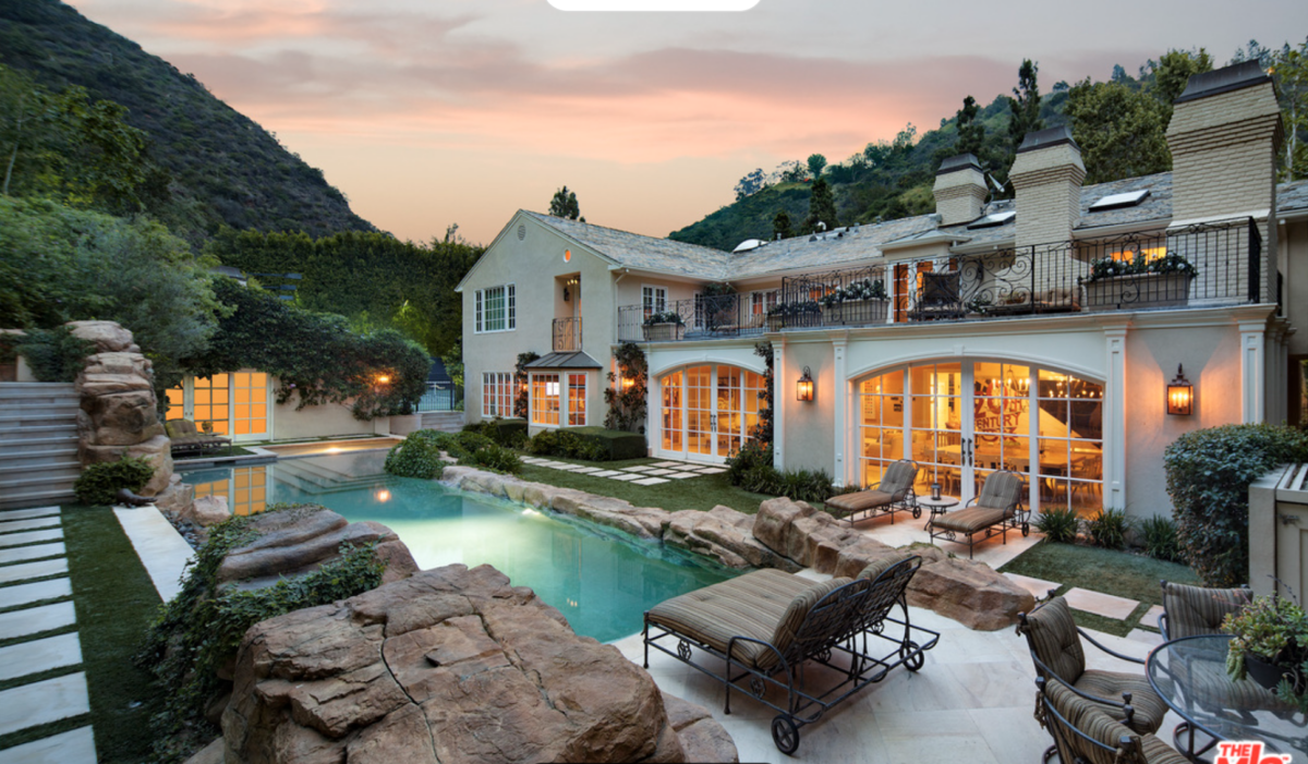 Niche Communities 5 a house with a pool and a large stone patio