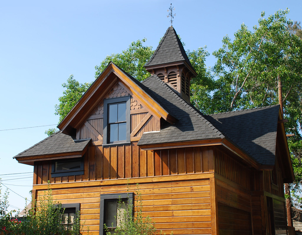 a wood house with a steeple
