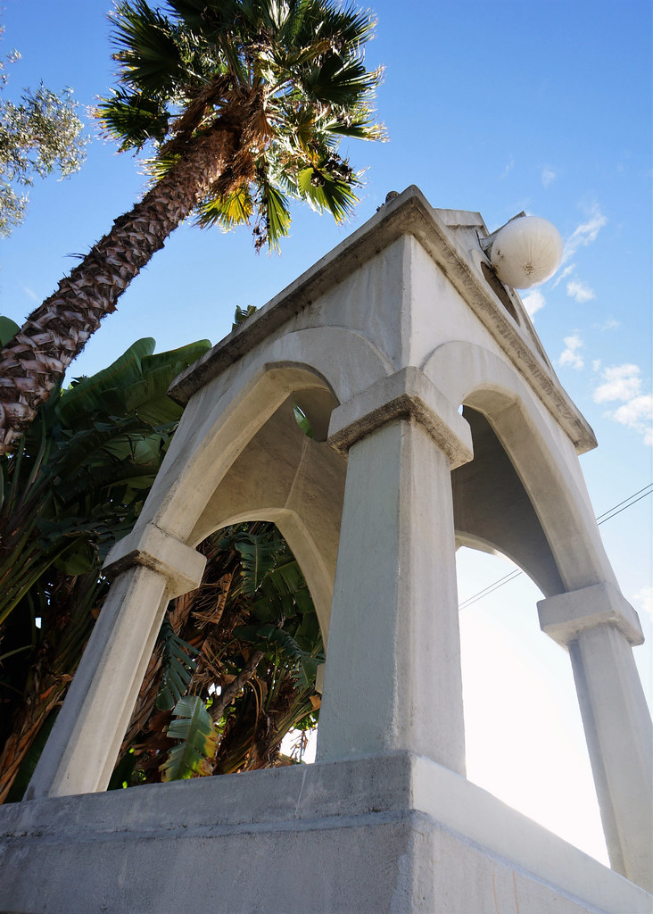 a white structure with arches and a ball on top