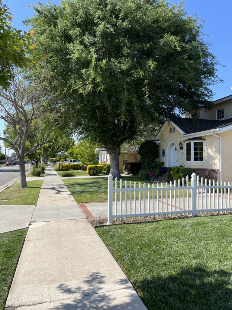 a white fence in front of a house