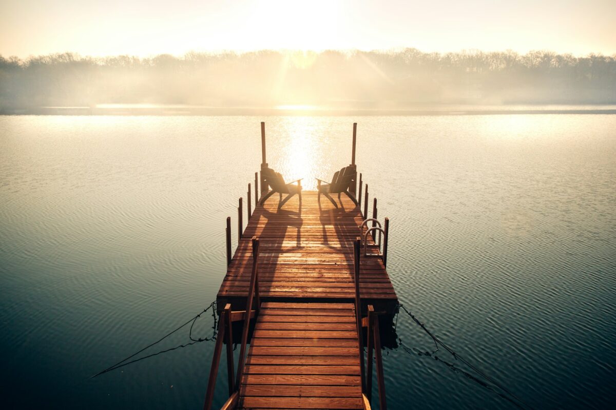 brown wooden dock on body of water during daytime