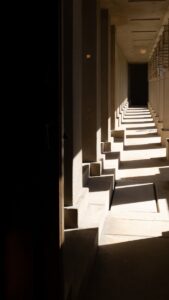 a long hallway lined with benches and windows