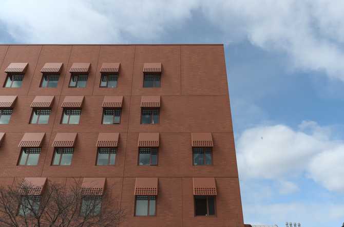 brown brick building by Micheal Maltzan