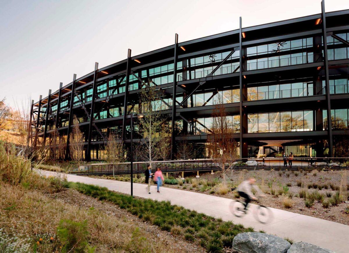 glass and steel building with sidewalk in front