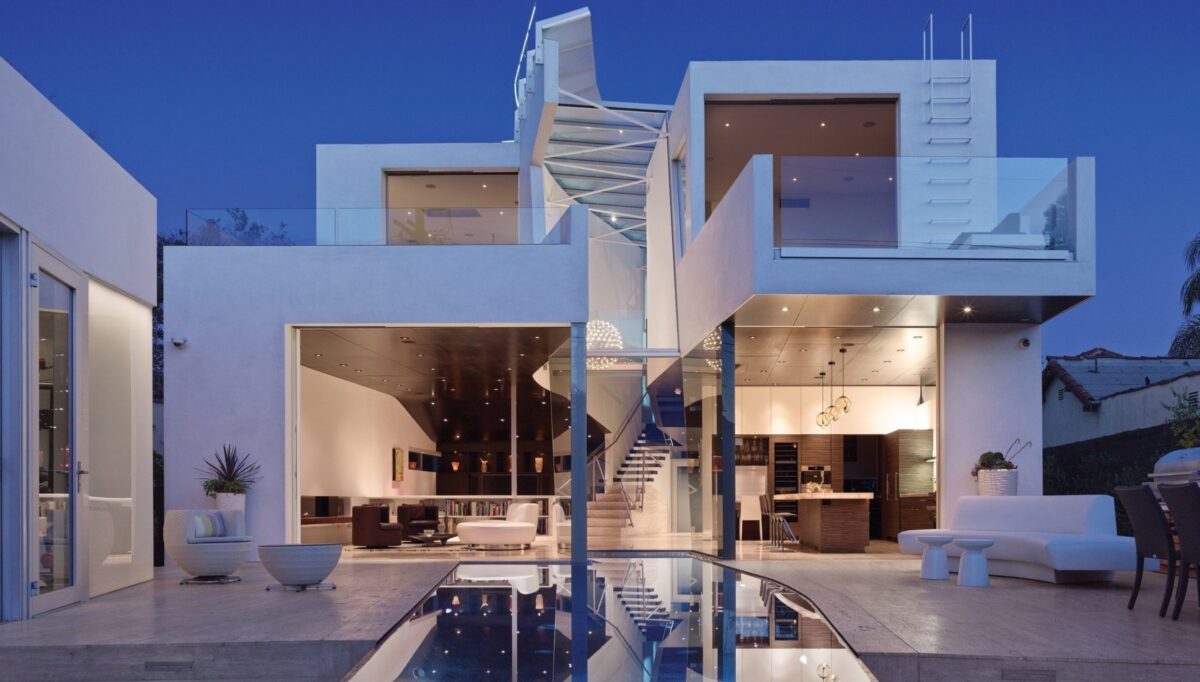 white and brown paneled modern luxury home at twlight