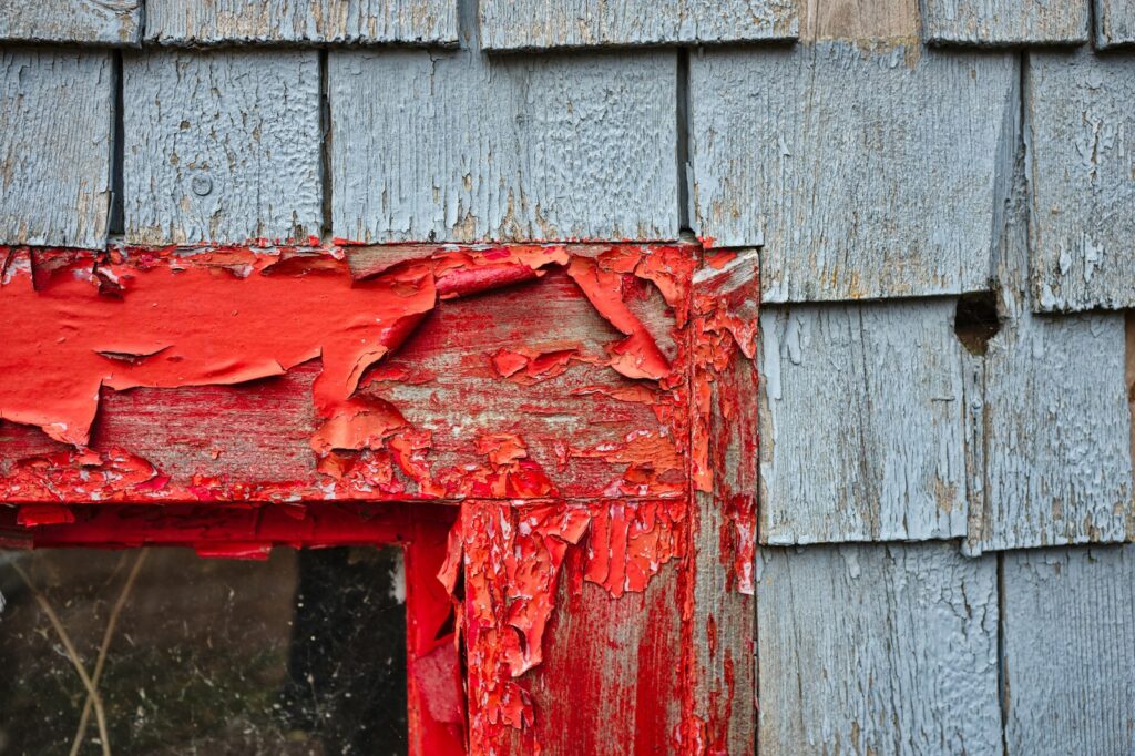 red paints on wooden frame during daytime