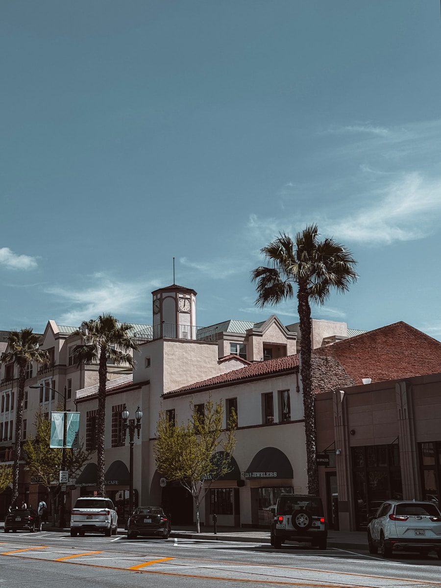a city street with palm trees and a clock tower