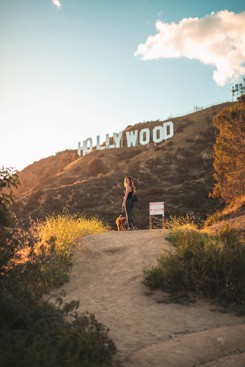 woman standing with brown dog