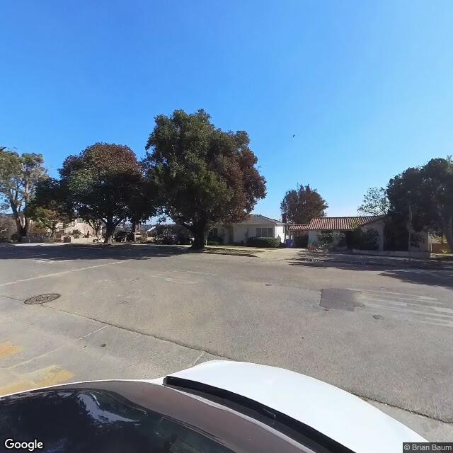 Pacific Palisades neighborhood street view showcasing upscale homes and tree-lined community streets