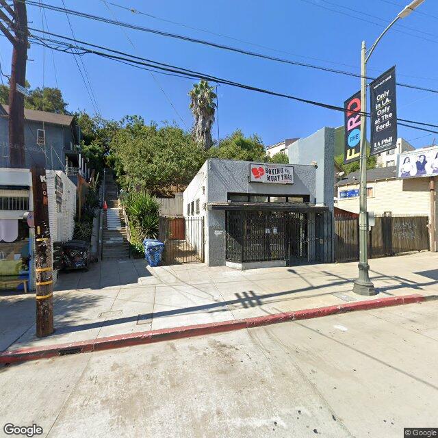 Street view of exclusive Los Angeles neighborhood showcasing luxury homes and upscale community architecture