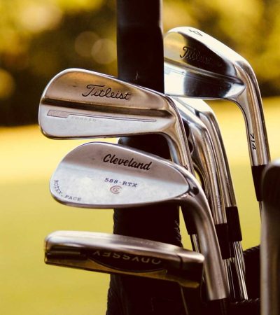 gray steel golf clubs on selective focus photo