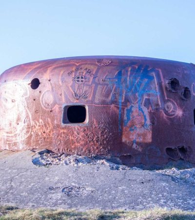 homes for sale with bunkers a rusted out round building with graffiti on it