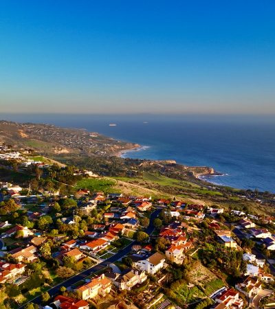 an aerial view of a city by the ocean