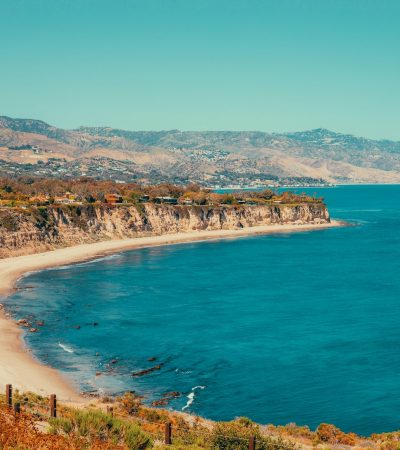 a view of a beach with a mountain in the background