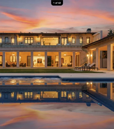 a house with a pool and a sunset