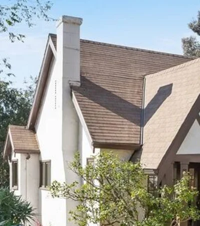 a house with trees and a blue sky