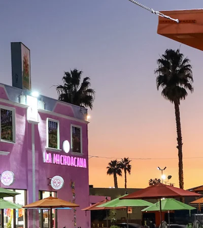 Panorama City a building with umbrellas and palm trees