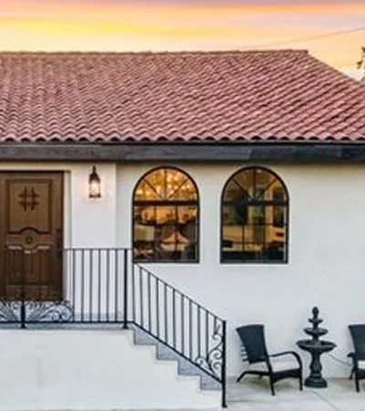 Windsor Village a white house with a black railing and chairs