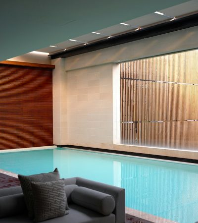luxury homes for sale in west hollywood  two gray sofas beside pool in room