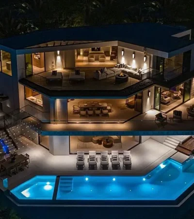 a house with a pool at night