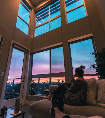 hollywood condos for sale a person sitting on a couch looking out a window