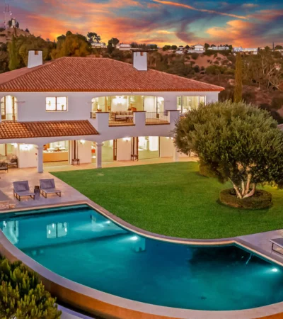 a house with a pool and trees