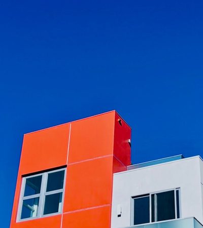 condos for sale in west hollywood  an orange and white building against a blue sky