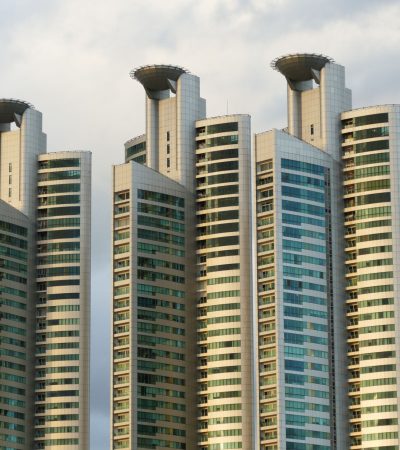 Modern luxury residential building in Century City, Los Angeles skyline in background
