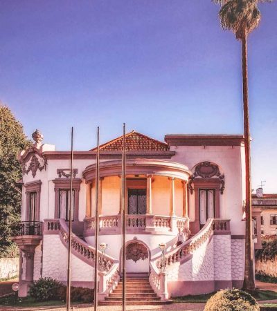 mansions for sale a white house with a palm tree in front of it