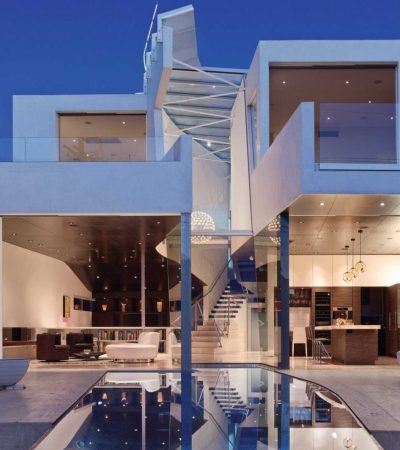 griffin enright homes white and brown paneled modern luxury home at twlight