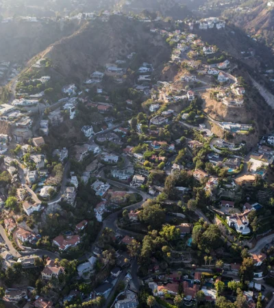 a aerial view of a hillside with houses and roads