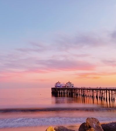 Malibu a pier that is next to a body of water