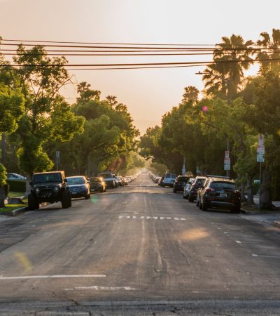 Upscale residential street in Mid City Los Angeles featuring modern homes and tree-lined architecture