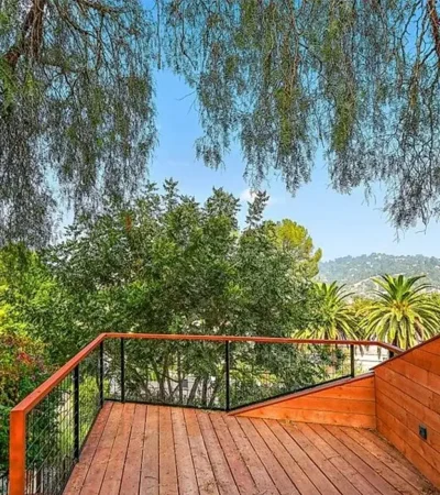 montecito heights a deck with a railing and trees