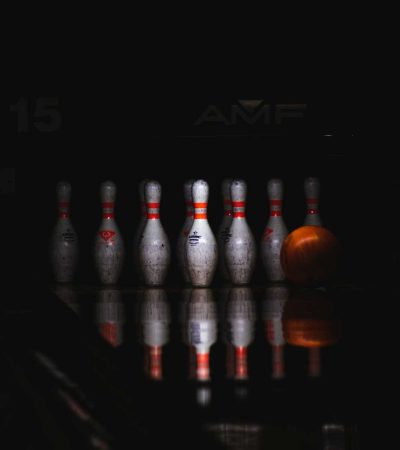 homes for sale indoor bowling alley clear glass bottles on black table
