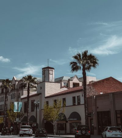 luxury homes for sale in pasadena ca a city street with palm trees and a clock tower