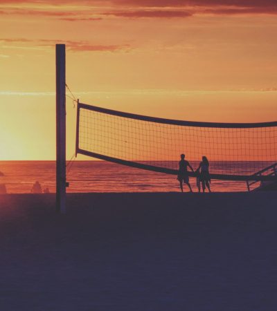 couples standing on seashore
