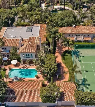 a tennis court and a building with a pool