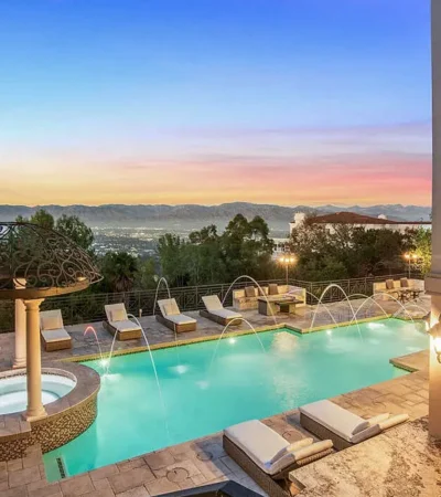 a pool with water jets and a fountain in the middle