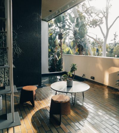 luxury homes for sale los feliz ca a living room with a table and two stools