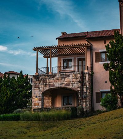 Elegant Tuscan-style villa with stone facade and manicured grounds in Los Angeles luxury real estate market