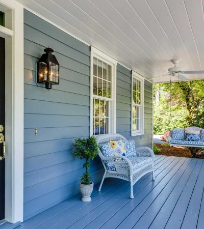 homes with wrap around porch for sale a porch with two chairs and a table on it